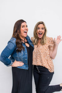 Amy Porterfield and Jamie Trull smiling excitedly in front of a white background. Their energy captures the spirit of connection, collaboration, and conversation in the online world—often shared through their engaging podcast episodes.