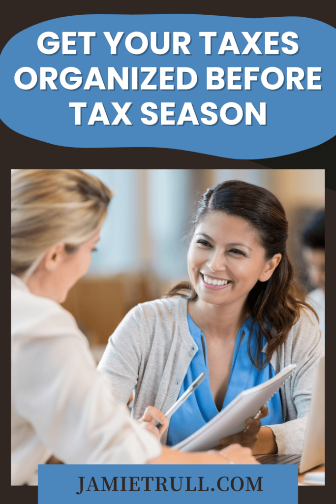 A professional office setup with a tax advisor pointing at a chart related to payroll taxes while the client listens attentively.