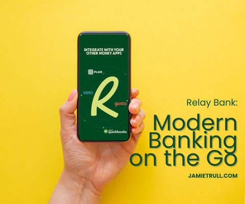 Hand holding phone with Relay Bank app, highlighting modern business checking and savings accounts with no monthly maintenance fees.