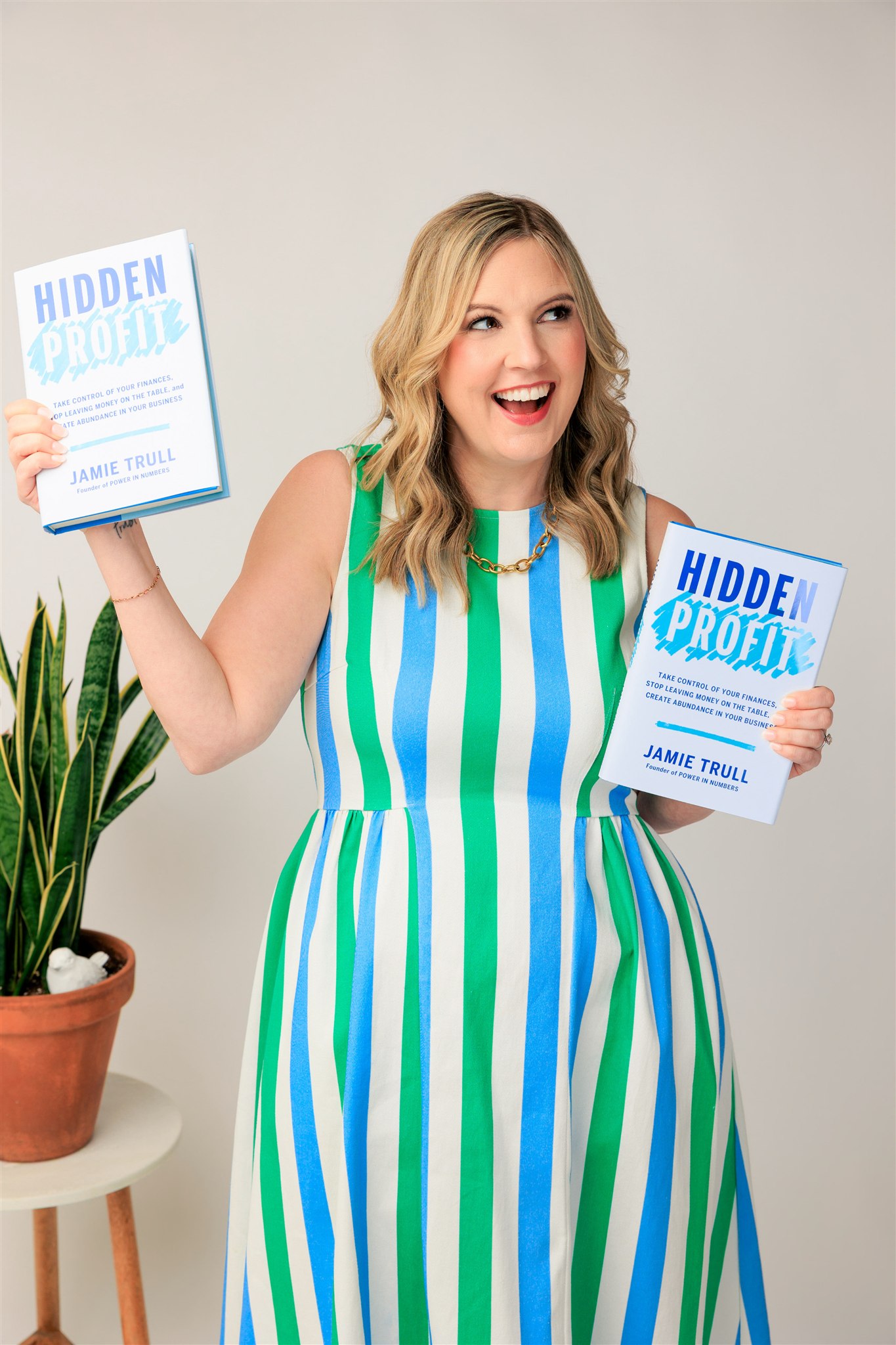 small business owner giving a Hidden Profit book to another entrepreneur to support financial literacy