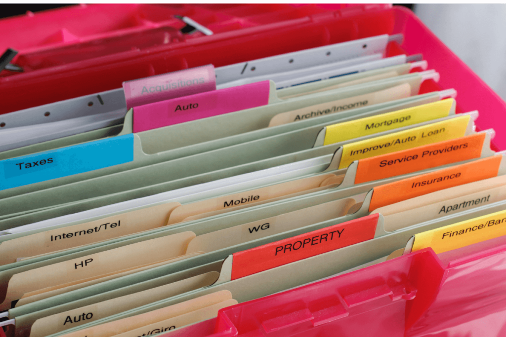 First step: separate your personal finances and your business finances. Picture is of a variety of home and business expenses organized in colorful file folders.