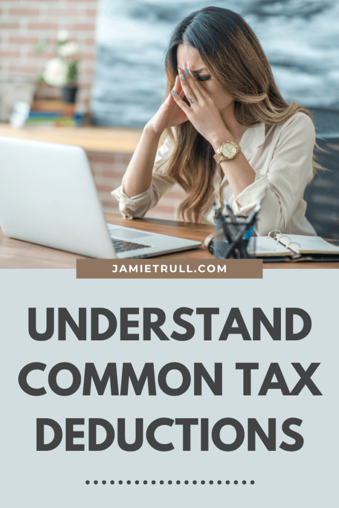 A woman business owner sitting in front of a laptop, looking overwhelmed. Her head is in their hands, illustrating the stress of filing taxes.